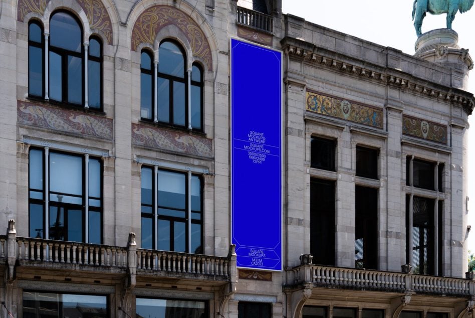 Bright blue vertical banner on historic stone building with decorative tilework